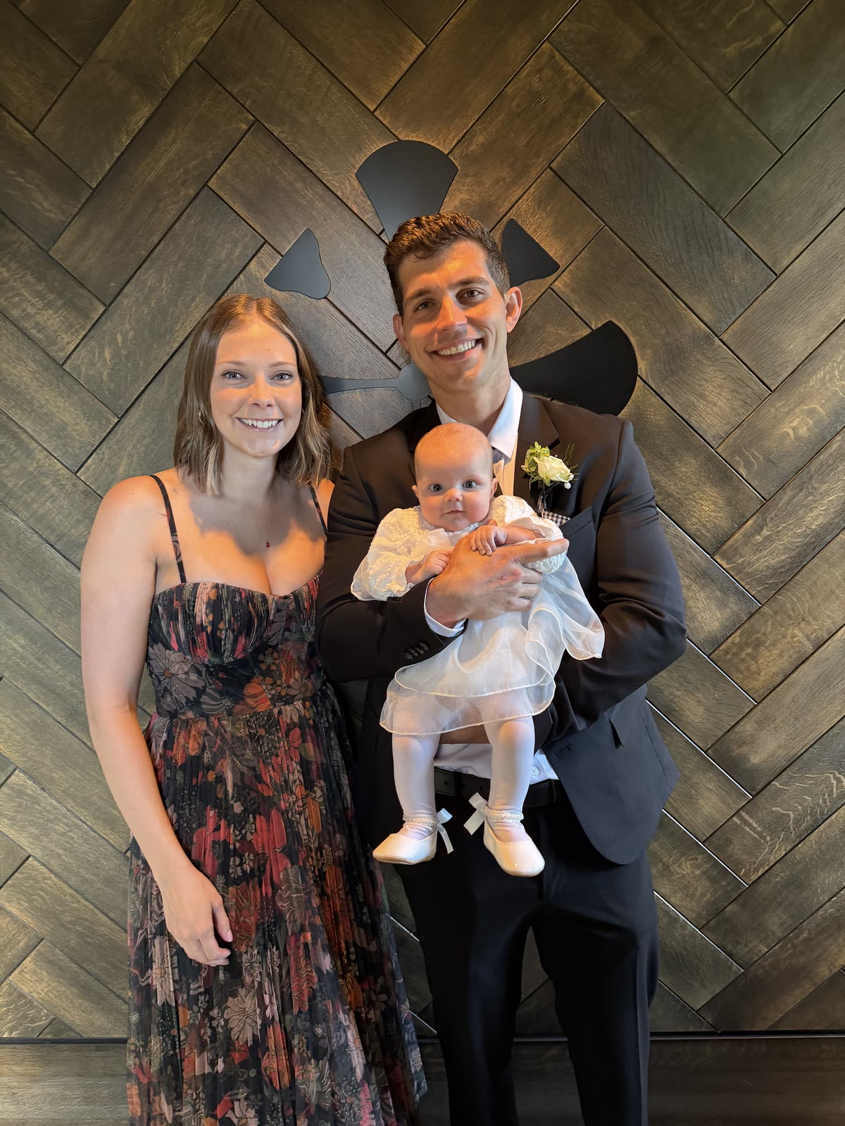 The family behind Safer Water Co., with baby Eloise in a white christening outfit.